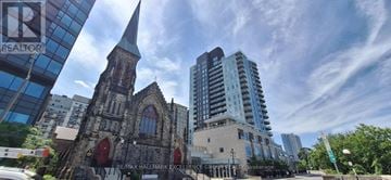 Ottawa condo for rent - A living room with a glass coffee table and a flat screen TV.
