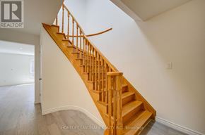 Toronto (Agincourt North) apartment for rent - A wooden staircase with a white wall on the side.
