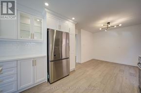 Toronto (Agincourt North) apartment for rent - A kitchen with white cabinets and a stainless steel refrigerator.