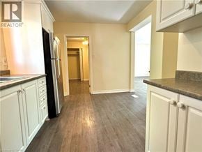 Kitchener apartment for rent - A kitchen with a refrigerator and cabinets.