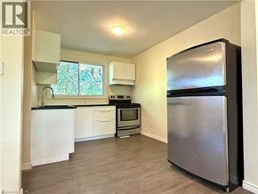 Kitchener apartment for rent - A kitchen with a refrigerator on the right side.