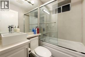 Vancouver apartment for rent - A white sink and toilet in a bathroom with a glass shower door.