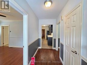 Richmond Hill (Crosby) apartment for rent - A hallway with a door on the right and a kitchen visible in the distance.