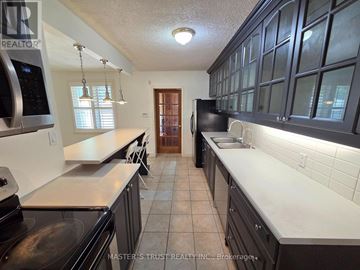 Richmond Hill (Crosby) apartment for rent - A kitchen with black cabinets and a white countertop.