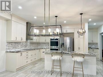 East Gwillimbury (Holland Landing) apartment for rent - A modern kitchen with a marble countertop and a large island.