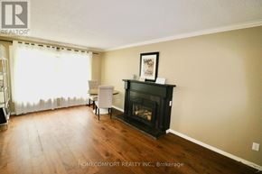 Aurora (Aurora Highlands) apartment for rent - A living room with a fireplace and a chair.