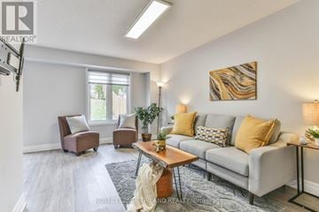 London North (North I) apartment for rent - A living room with a grey couch, two chairs, a coffee table, and a painting on the wall.