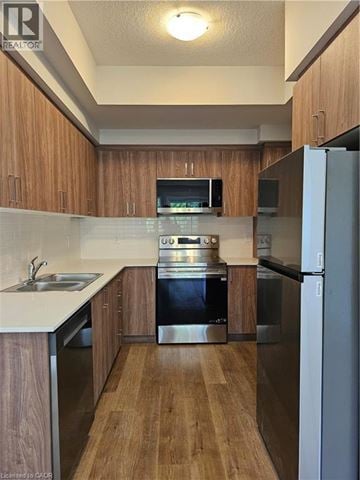 Cambridge apartment for rent - A kitchen with wooden cabinets and stainless steel appliances.