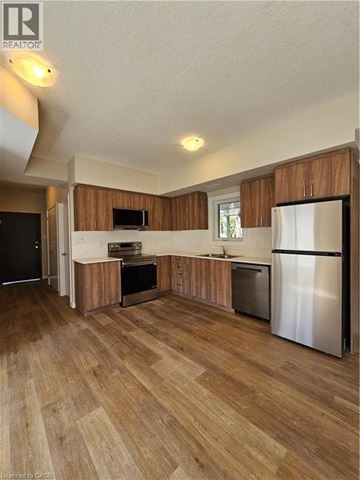 Cambridge apartment for rent - A kitchen with wooden cabinets and a refrigerator.