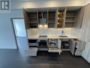 Toronto (Bayview Village) condo for rent - A modern kitchen with a large island and wooden cabinets.