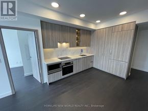 Toronto (Bayview Village) condo for rent - A modern kitchen with wooden cabinets and a marble countertop.
