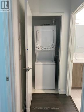 Toronto (Humber Heights) condo for rent - A white washing machine is in a small room.