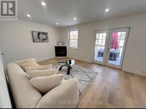 London South (South F) apartment for rent - A living room with a couch, coffee table, and a window.