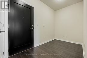 Mississauga (Hurontario) condo for rent - A room with a black door and wooden flooring.