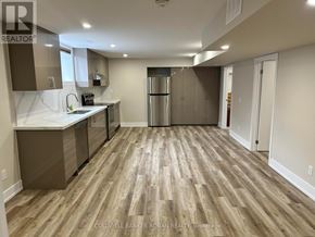 Essa apartment for rent - A kitchen with wooden floors and stainless steel appliances.