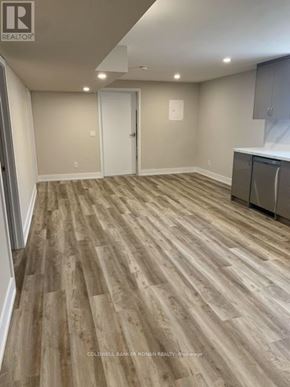 Essa apartment for rent - A room with wooden flooring and a white door.