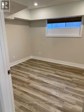 Essa apartment for rent - A room with a wooden floor and a window.