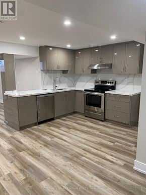 Essa apartment for rent - A modern kitchen with wooden flooring and a center island.