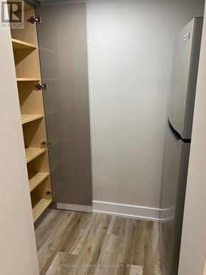 Essa apartment for rent - A small walk in closet with a sliding door and shelves.