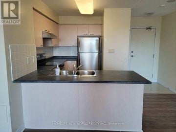 Markham (Commerce Valley) condo for rent - A kitchen with a sink and refrigerator.