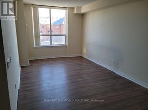 Markham (Commerce Valley) condo for rent - A room with a window and wooden flooring.
