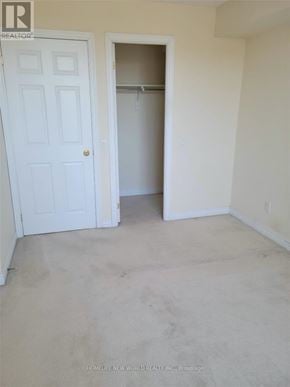 Markham (Commerce Valley) condo for rent - A white door is on the left and an open closet on the right.