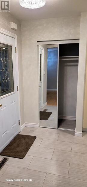 Mississauga (Clarkson) apartment for rent - A hallway with a white door and a brown doormat.