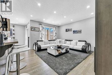 Stratford apartment for rent - A modern living room with a white sofa set and a grey rug.