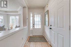 Burlington (Orchard) apartment for rent - A hallway with a white door and a mirror on the wall.
