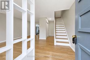 Mississauga (Applewood) townhouse for rent - A hallway with a staircase and a door with a lock.