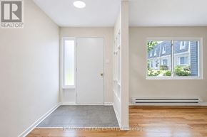 Mississauga (Applewood) townhouse for rent - A room with a white door and a window showing a view of a house across the street.
