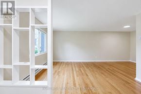 Mississauga (Applewood) townhouse for rent - A room with wooden flooring and white walls.