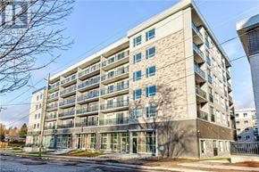 Waterloo condo for rent - A modern apartment building with a clear sky in the background.