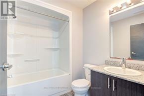 Waterloo condo for rent - A bathroom with a toilet, sink, and shower.