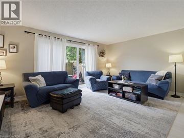 London townhouse for rent - A living room with blue furniture and a grey rug.