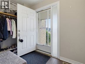 London townhouse for rent - A white door with a glass window is open to a hallway.