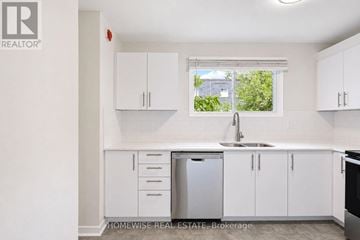 Mississauga (Applewood) townhouse for rent - A white kitchen with a sink and cabinets.