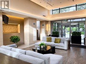Mississauga (Central Erin Mills) condo for rent - A modern living room with a white couch and a glass coffee table.