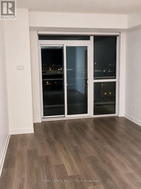 Mississauga (Central Erin Mills) condo for rent - A room with a view of the city through a glass door.