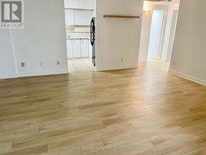 Ottawa condo for rent - A room with wooden flooring and white walls.
