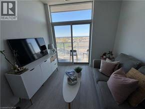 Hamilton condo for rent - A living room with a grey couch and a flat screen TV.