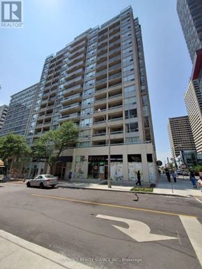 Toronto (Yonge-Eglinton) condo for rent - A tall apartment building with a car parked in front of it.