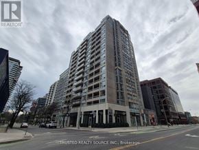 Toronto (Yonge-Eglinton) condo for rent - A tall building with many windows is the main focus of the image.