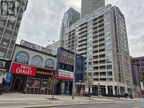 Toronto (Yonge-Eglinton) condo for rent - A city street with a tall building in the background and a dentist office in the foreground.