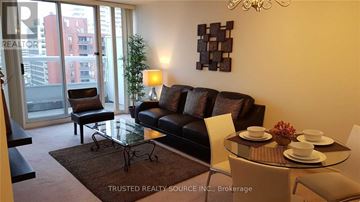 Toronto (Yonge-Eglinton) condo for rent - A living room with a glass table and a couch.