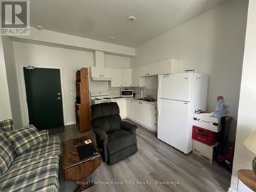 Centre Wellington (Elora/Salem) triplex for rent - A kitchen area with a refrigerator, microwave, and oven.