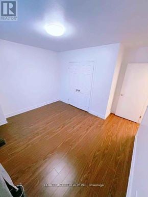 Toronto (Rexdale-Kipling) townhouse for rent - A room with wooden flooring and a white door.