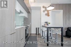 Toronto (Church-Yonge Corridor) condo for rent - A modern kitchen with a dining area in a real estate brokerage.