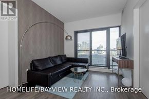 Toronto (Church-Yonge Corridor) condo for rent - A living room with a black leather sofa and a television.