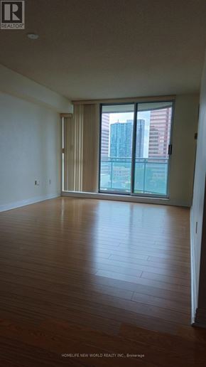 Toronto (Newtonbrook East) condo for rent - A room with wooden floors and a sliding glass door.